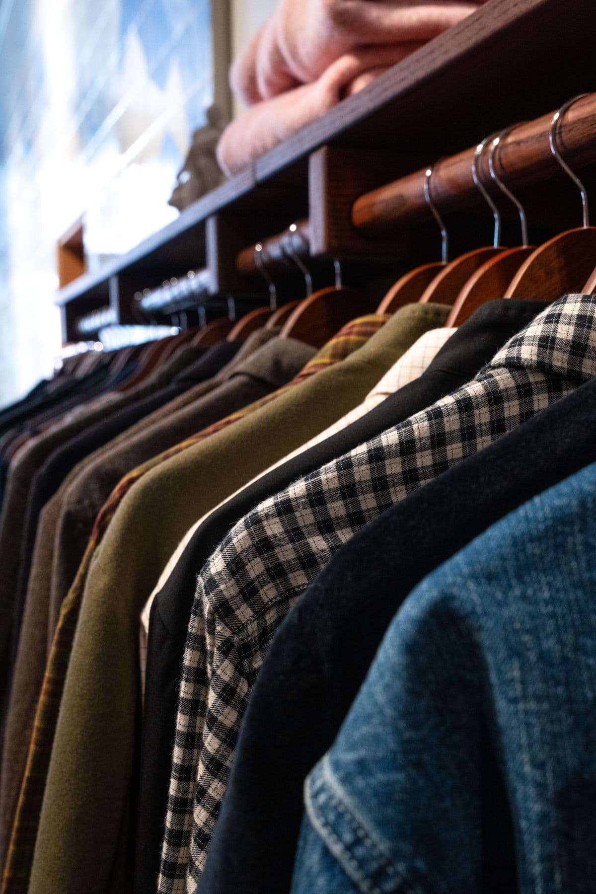 A rail of shirts and denim at Fazenda